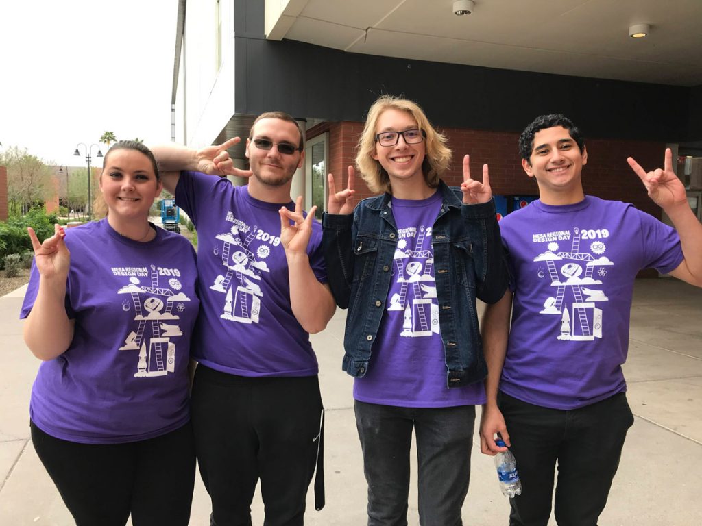 Professional development event attendees with Lopes Up hand sign